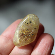 Load image into Gallery viewer, Rutilated Quartz tumbles to focus light