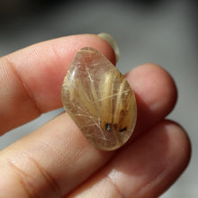 Load image into Gallery viewer, Rutilated Quartz tumbles to focus light